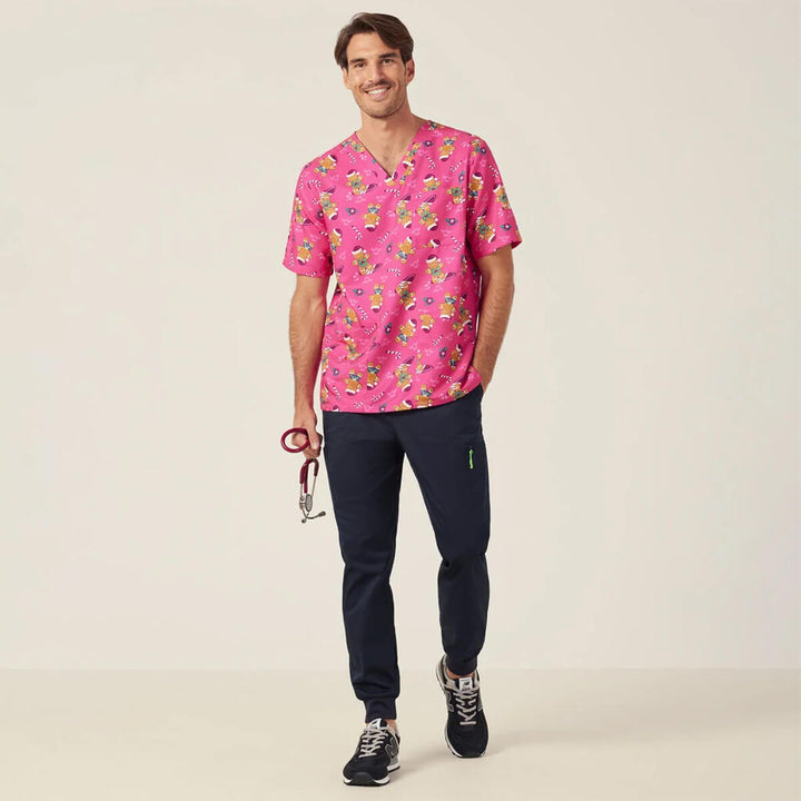 NNT CATUXV XMAS Gingerbread Surfer Print Scrub Top Pink worn by man holding stethoscope, full body picture