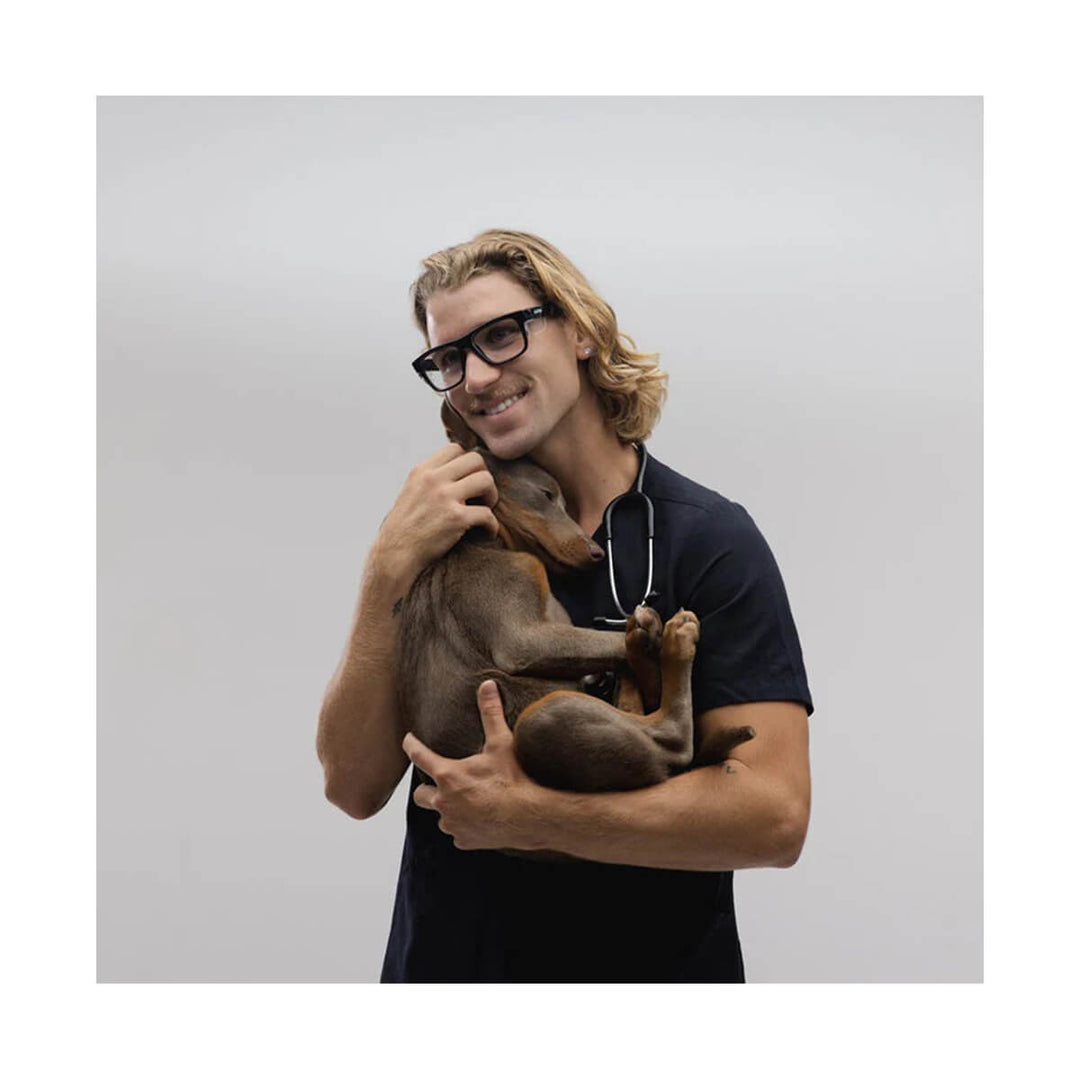 SafeStyle Fusions Black Frame Blue Light Blocking Lens worn by man holding dog